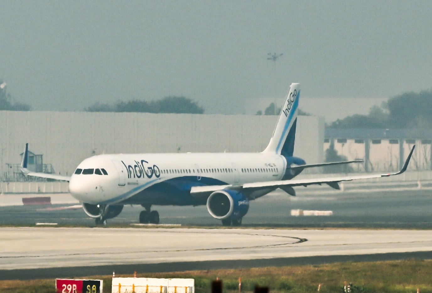 IndiGo aircraft parked on the airport apron during a security check