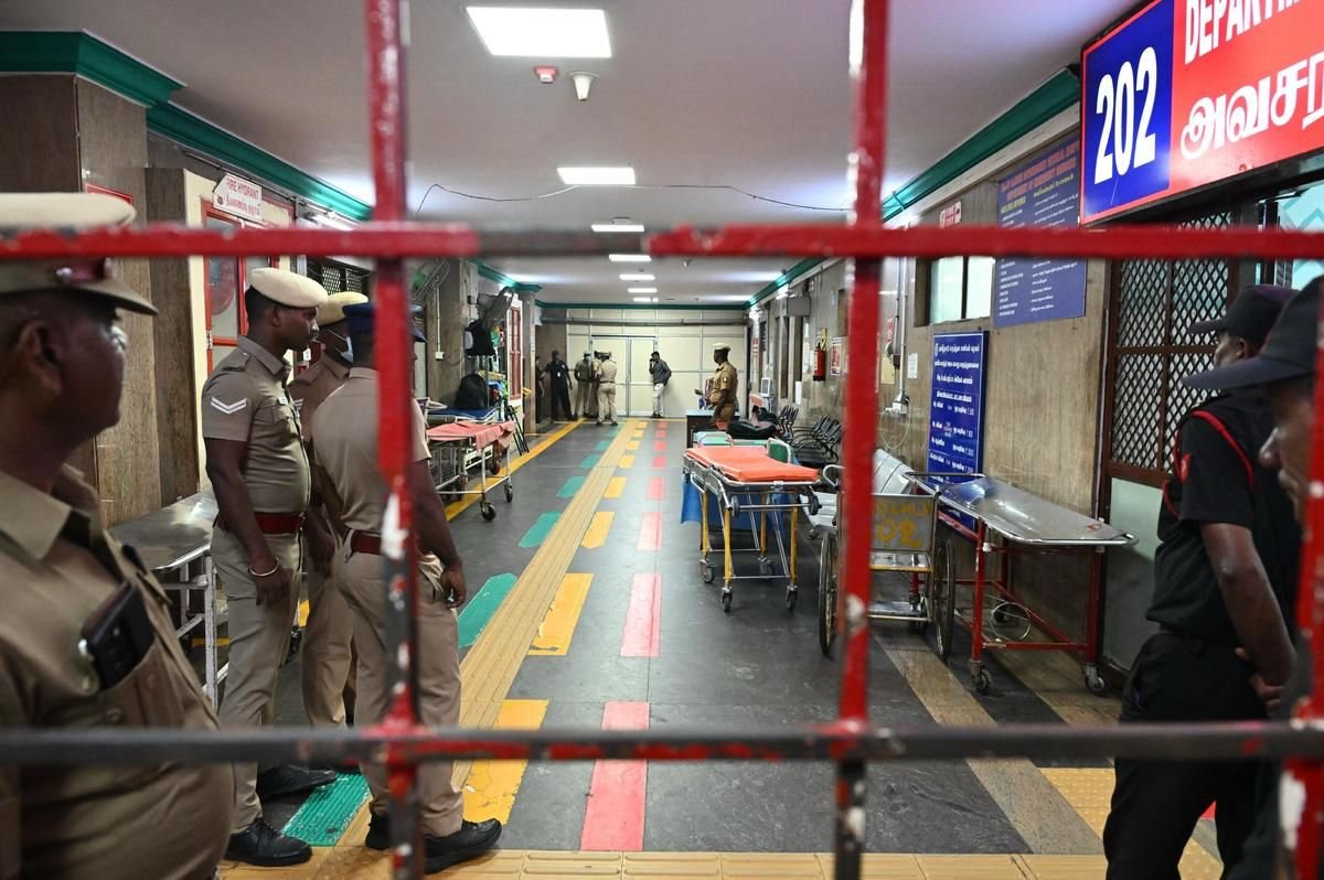 Emergency responders and medical personnel assist workers following an ammonia gas leak at a seafood processing facility in Tiruvallur district, Tamil Nadu, as affected employees receive treatment.