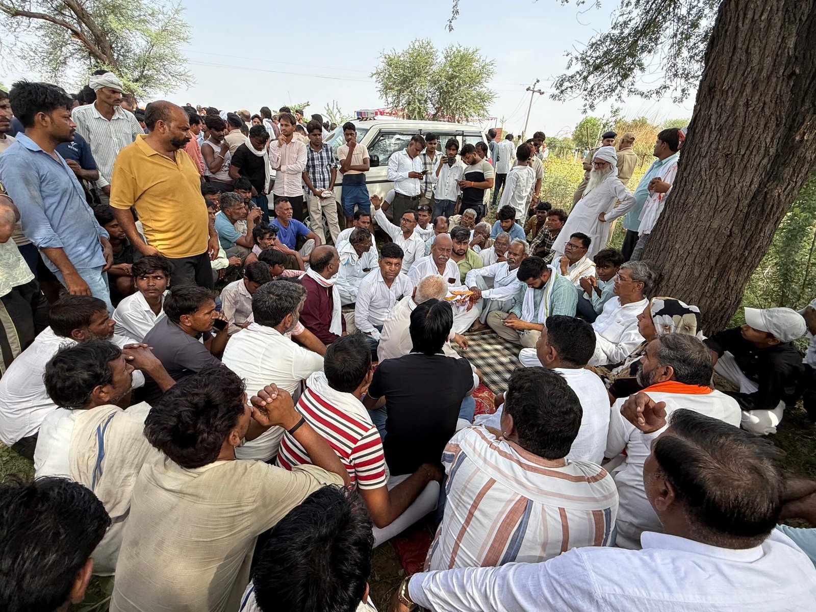 Family members and villagers stage a protest in Rajasthan's Karauli district after three people were electrocuted by a snapped high-tension power line, demanding compensation and government jobs.