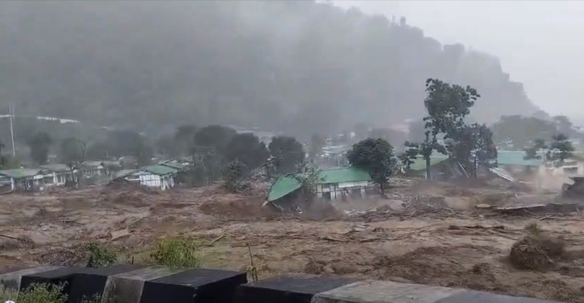 Flash flood waters carrying debris and mud washing through residential areas and damaged houses in Keyi Panyor district of Arunachal Pradesh