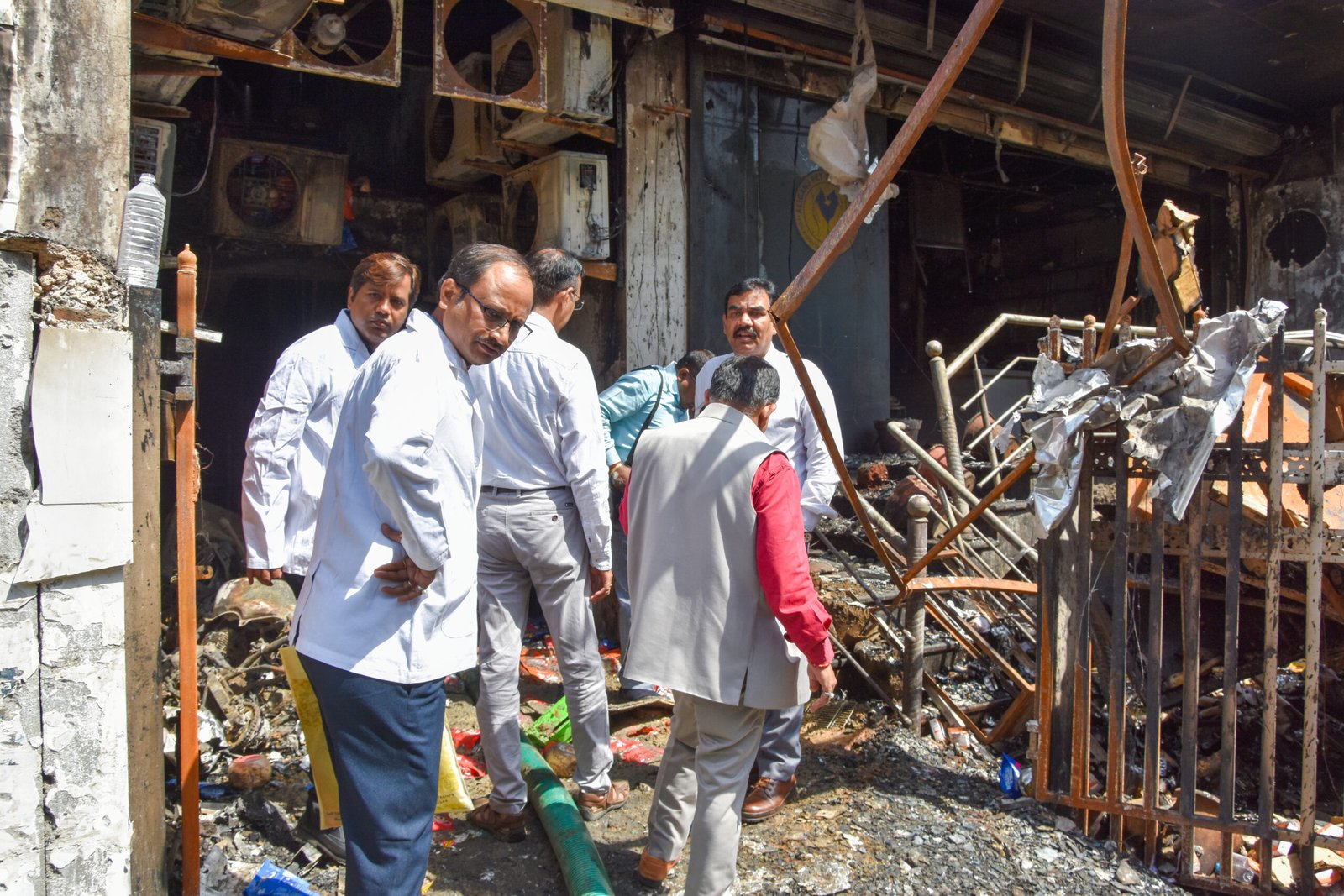Emergency rescue operations and police investigation at the three-storey commercial building near Purania Chauraha in Aliganj, Lucknow, following a devastating fatal fire incident.