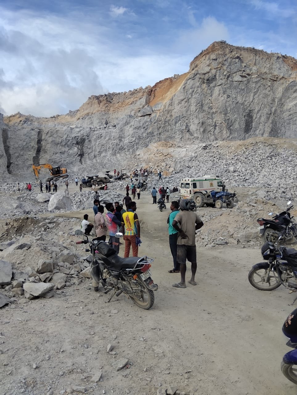 Rescue personnel and heavy machinery clear massive boulders at a stone quarry in Madapatna village, Bengaluru South, following a rock collapse that trapped multiple migrant labourers.