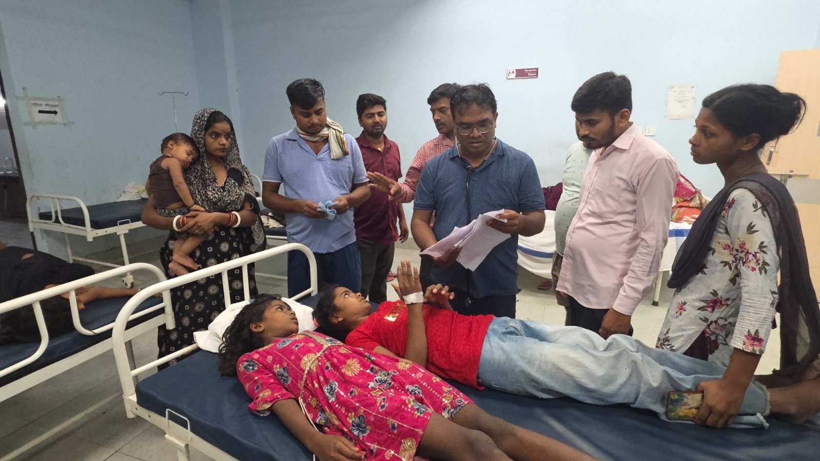 Doctors attend to patients, including children, receiving treatment in a hospital ward after a suspected food poisoning incident in Gopalganj, Bihar.