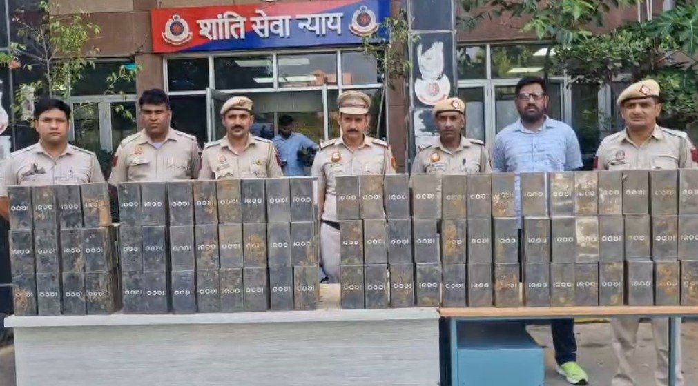 Police officers display cartons containing hundreds of recovered smartphones after arresting three men in connection with the theft of a mobile phone consignment