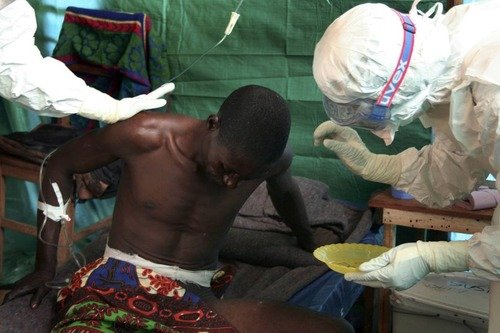 Healthcare workers wearing protective equipment attend to patients and carry out Ebola response measures at a treatment centre in the Democratic Republic of the Congo.