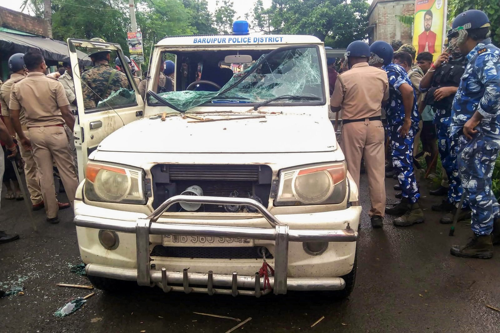 Police personnel patrol a street in Baruipur, West Bengal, after prohibitory orders were imposed following unrest over the death of a 12-year-old girl.