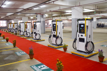 An electric vehicle plugged into a public EV charging station point, representing Tamil Nadu's green mobility roadmap to scale up clean energy infrastructure by 2031.