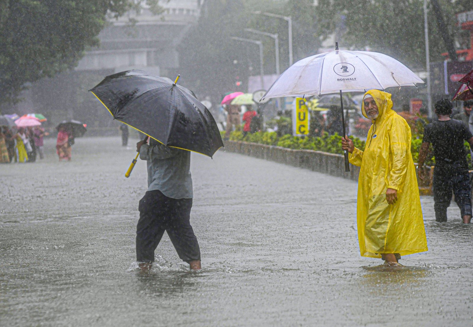Rescuers navigating a flooded street in Maharashtra using boats to evacuate stranded residents amidst heavy rains.