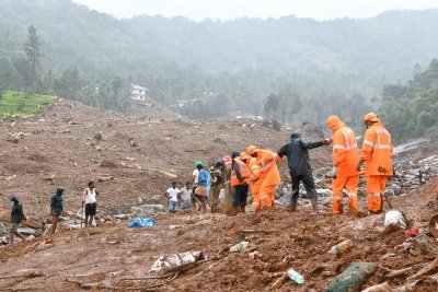 Rescue teams and excavators clearing thick mud and landslide debris near the Meenakshi Bridge construction site in Wayanad, Kerala.