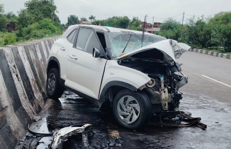Damaged car at the accident site on the Jhansi-Kanpur national highway after hitting a road divider