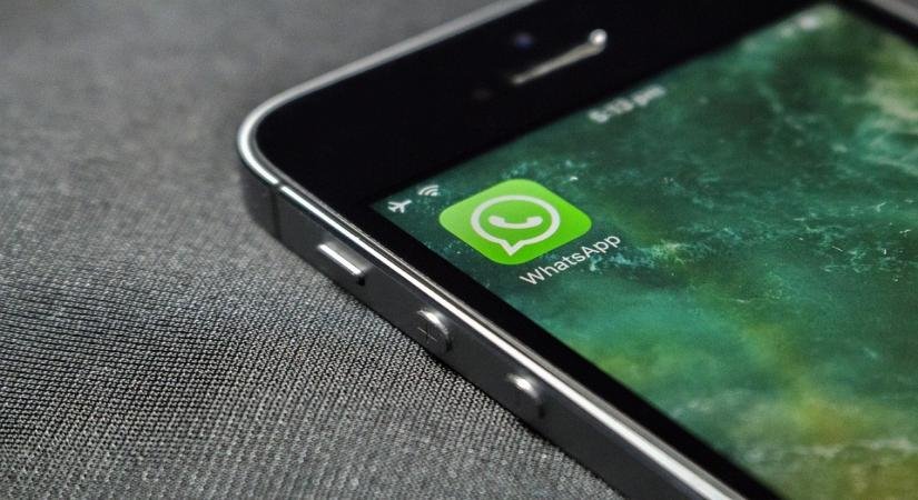 A smartphone screen displaying the WhatsApp app interface with a popup prompt requesting date of birth details.