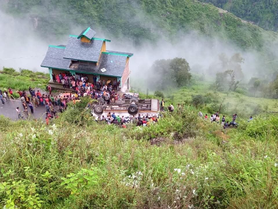 Rescue teams and local residents carry out relief operations near a mangled private bus at the accident site in Chamba gorge, Himachal Pradesh.