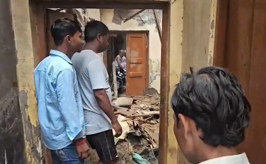 Rescue workers and locals searching debris after a house roof collapse in New Usmanpur, Northeast Delhi.