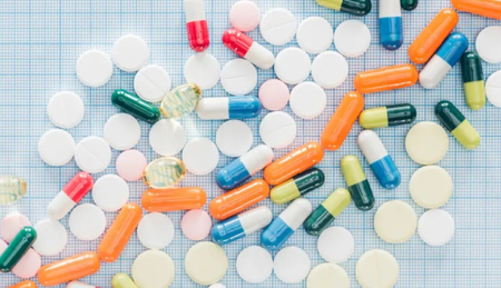 Pediatric cough syrup and medicinal bottles representing the Health Ministry ban on specific FDCs for young children