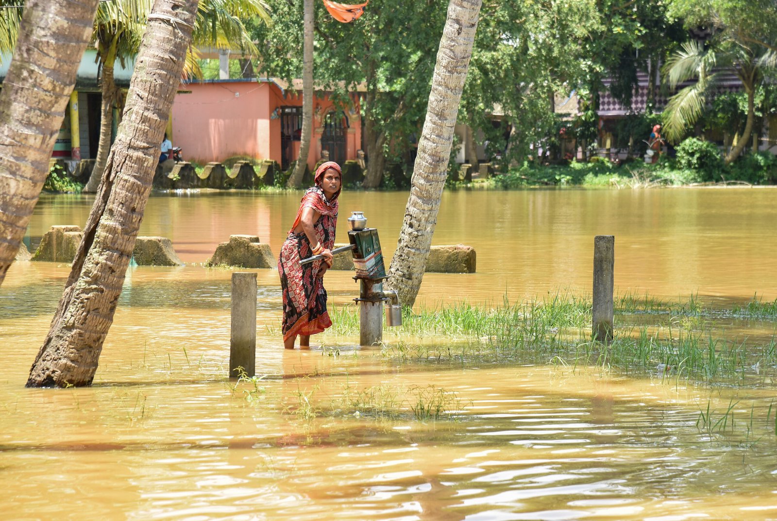 Emergency personnel and rescue boats evacuating marooned villagers from submerged residential areas in flood-affected Odisha