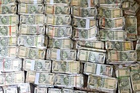 Bundles of seized Indian currency notes worth over ₹9 crore recovered by Income Tax officials and police in Bengaluru's Electronic City