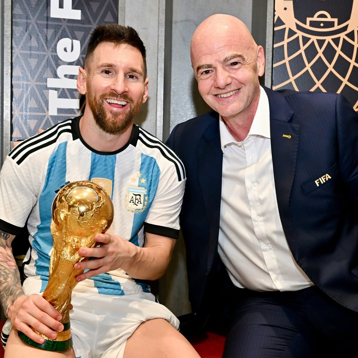 FIFA President Gianni Infantino celebrating alongside Argentina captain Lionel Messi with the World Cup trophy