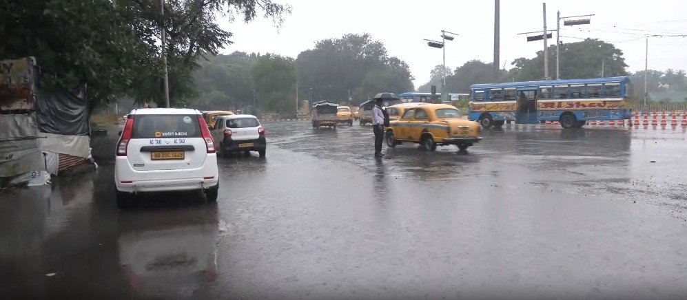 Vehicles navigate through a submerged street in Kolkata after heavy rains lashed parts of southern West Bengal on Wednesday.