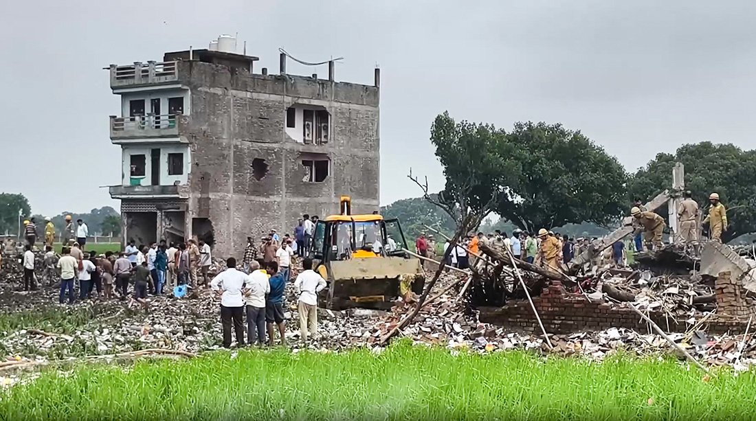 : UP Police and rescue personnel clearing debris at the site of a firecracker factory blast in Kaushambi