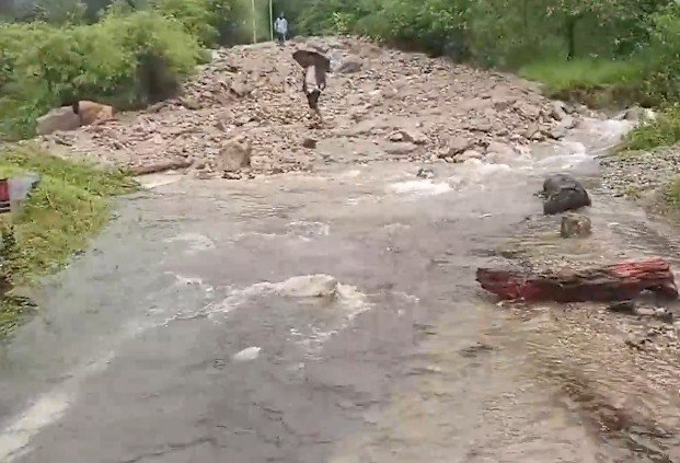 SDRF personnel carrying out rescue and debris clearance operations in a rain-hit village in Uttarakhand